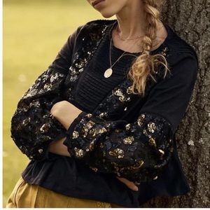 Anthropologie black and gold top, with sequins.